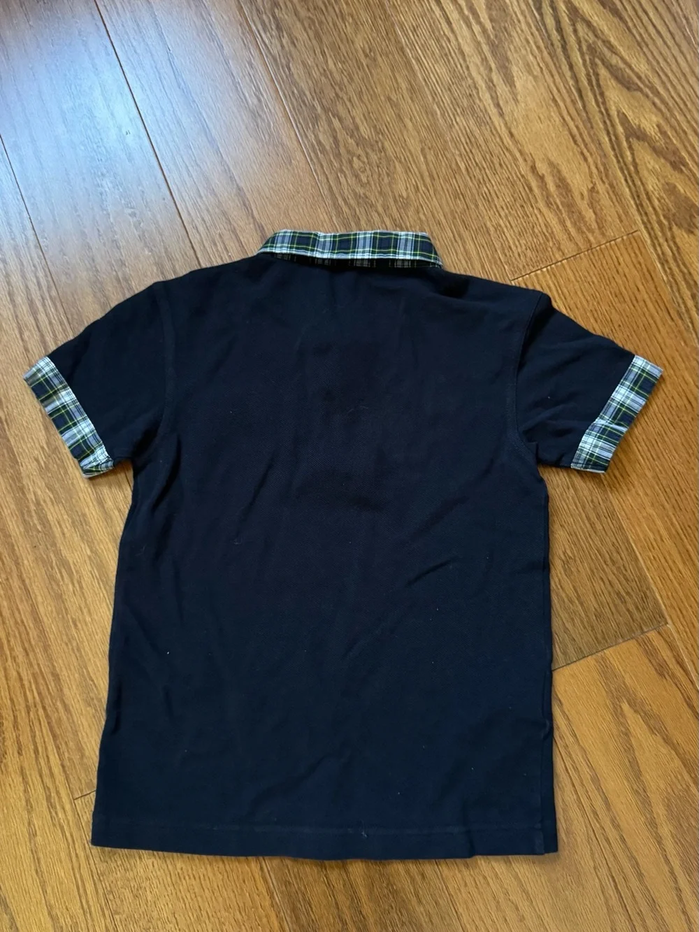 Fred Perry black polo shirt with plaid collar and sleeve cuffs, size 6-7 years